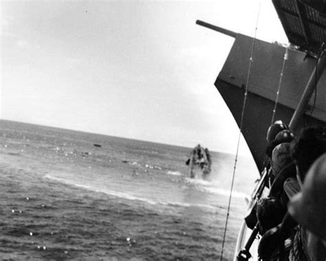 Crew of USS Yorktown watch as Destroyer USS Hammann sinks stern high after being stuck by ...