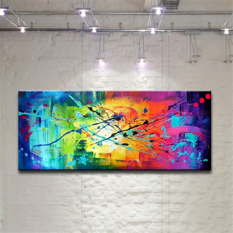 an abstract painting hangs on the wall