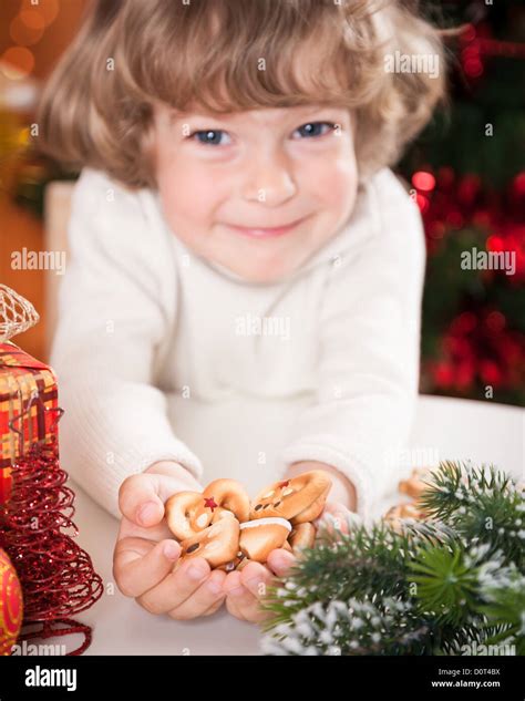 Funny child holding cookies Stock Photo - Alamy