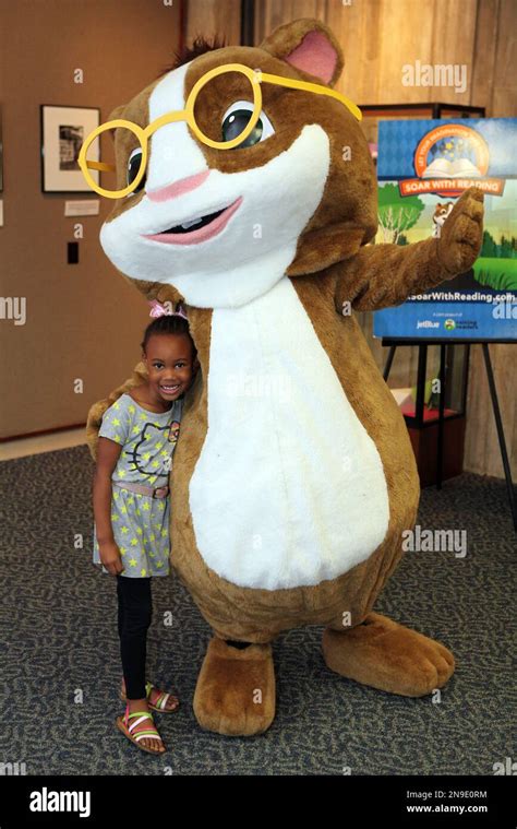 PBS KIDS mascot Hooper poses with a child during the Soar with Reading event, a JetBlue and PBS ...