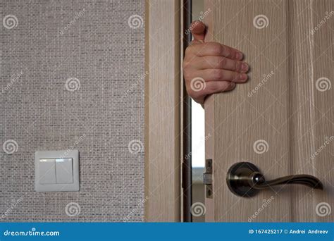 Hand of the Woman Who is Behind the Door, Hold the Door, Opening or Closing it. Stock Image ...