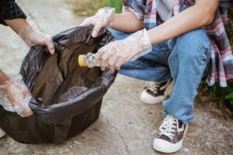 Hand Picking Up Plastic Waste and Put in the Trash Bag Stock Image ...