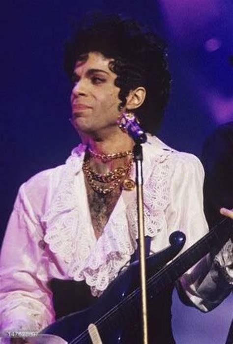 prince performing on stage with his guitar