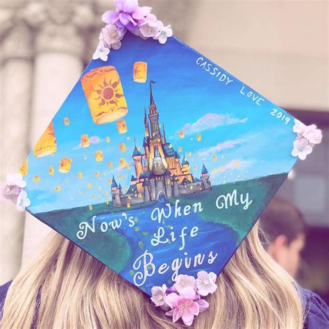 a woman wearing a graduation cap that says now's when my life begins,