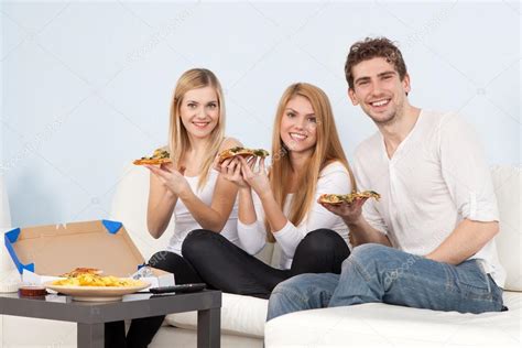 Group of young people eating pizza at home — Stock Photo © gdolgikh #46206739