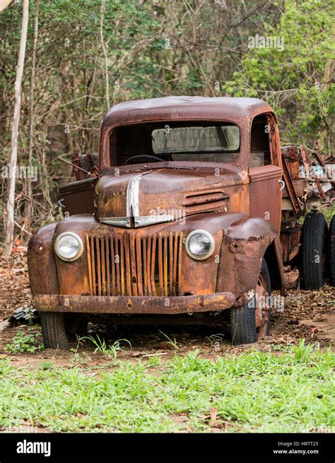 Old abandoned rusty Ford truck in field Stock Photo - Alamy