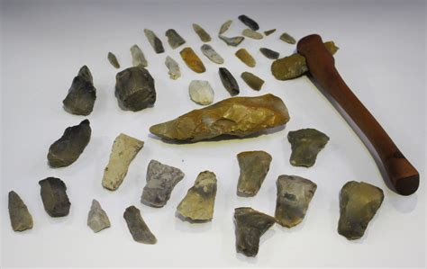 A collection of archaeological stone artifacts, including a tranchet ...