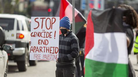 Pro-Palestine protestors descend on Oscars waving signs and flags as ...