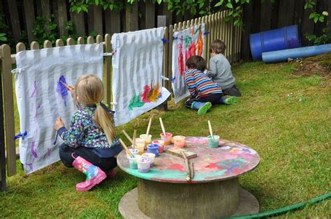 Painting on a big scale. I like the cable reel as a table...Stomping in the Mud Outdoor Learning ...