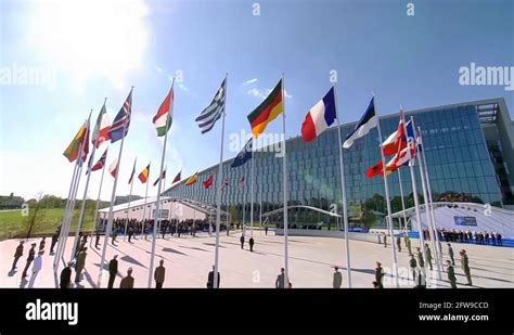 National flags fluttering during handover ceremony at NATO Headquarter ...