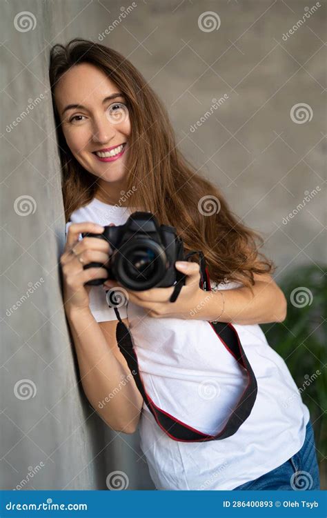 Girl Photographer with a Camera Smiling Near the Wall Stock Image ...