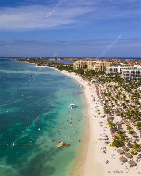 Aerial view of people on beach along shoreline, Aruba - Stock Image ...