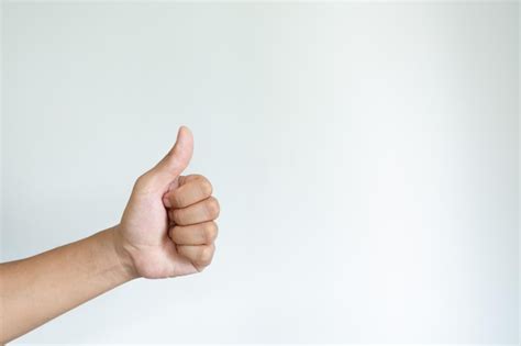 Premium Photo | Closeup of asian male left hand showing thumbs up sign ...