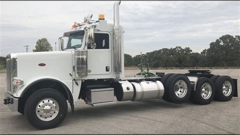 a white semi truck parked in a parking lot