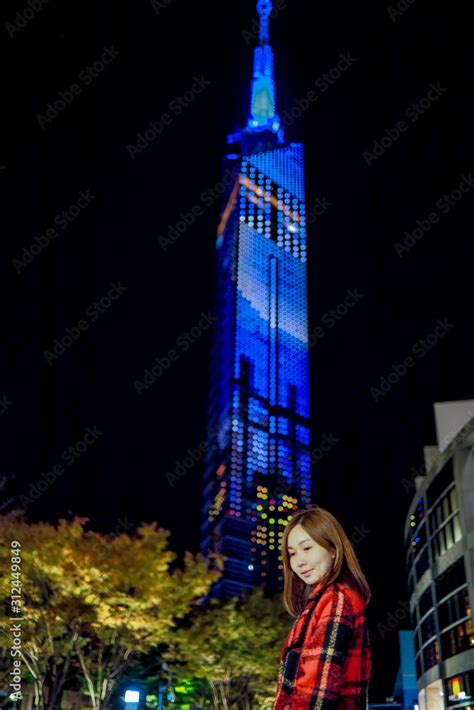 Fukuoka Tower at night from in front area. Tower structure Design on blue light and be one of ...