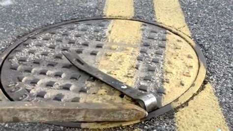 Man Tries to Fix the Universe By Realigning One Manhole Cover at a Time