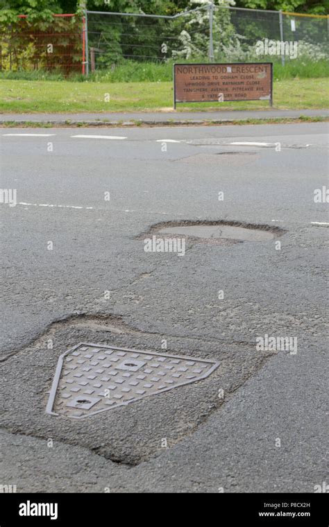 Pot holes in Carterton, Oxfordshire UK. 13th May 2018. UK Weather: Pot holes in West Oxfordshire ...