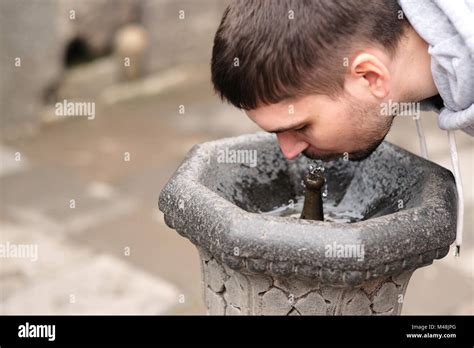 Man drinking water from fountain Stock Photo - Alamy