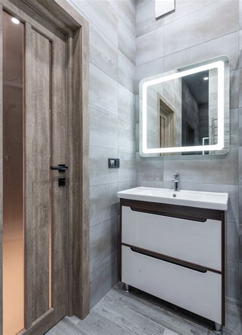 Contemporary bathroom interior with washbasin under mirror in house ...