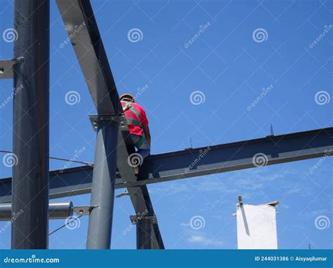 Construction Workers Installing Metal Roof Trusses at the Construction ...