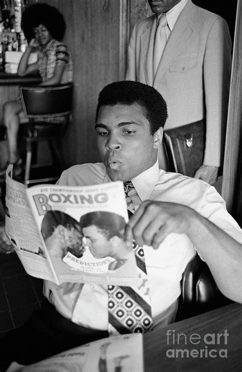 Muhammad Ali Reading A Magazine by Bettmann