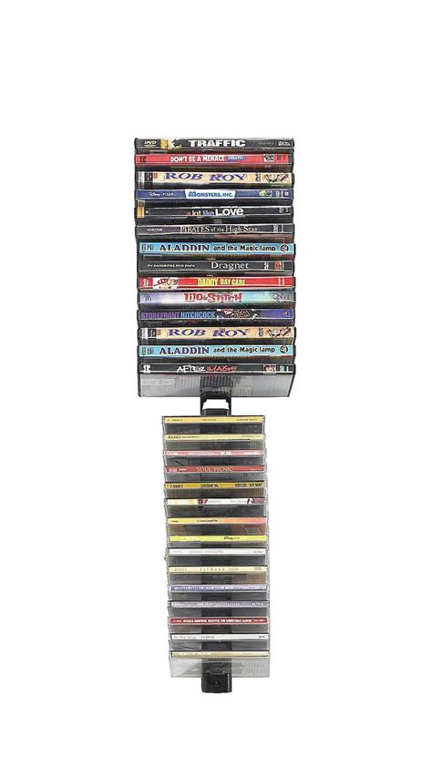 a stack of dvd's sitting on top of a metal rack in front of a white ...