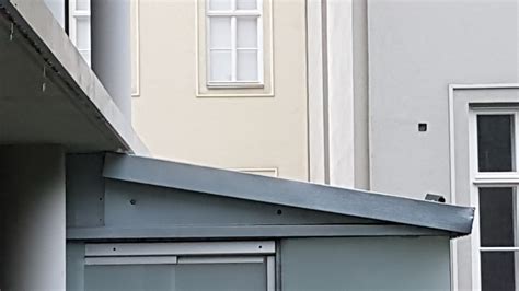 metal - Solutions for noisy-in-the-rain tinned roof - Home Improvement Stack Exchange