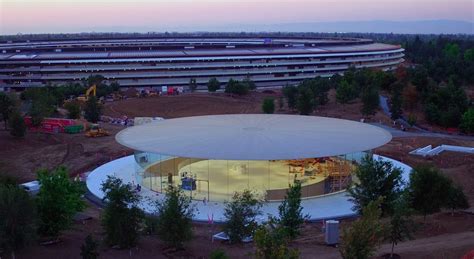 Apple Park sunset footage shows entrance to Steve Jobs Theater with its lobby lights on