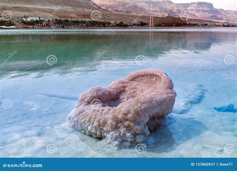 Israel. the Salt Flats of the Dead Sea. Aquamarine Color of Water. Chair is Covered Large Layer ...