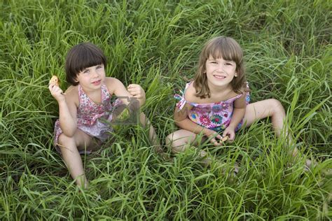 two girls sitting in the grass in meadow. Summer time. Friendshi by elenarostunova Vectors ...