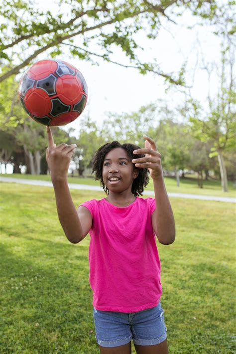 Young Girl Playing a Football · Free Stock Photo