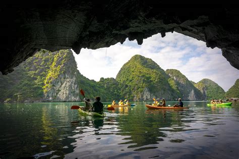 Kayakers going through cave in ha Long Bay - Find Away Photography