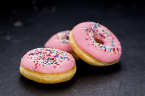 Premium Photo | Pink glazed donuts closeup shot