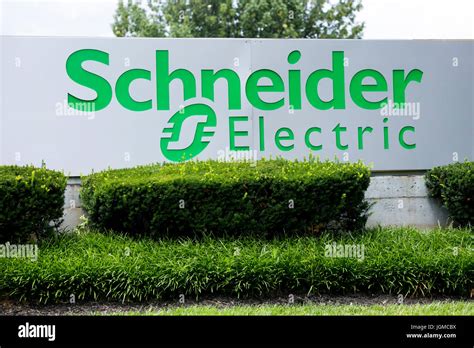 A logo sign outside of a facility occupied by Schneider Electric in ...