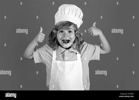 Excited funny chef cook. Child chef dressed cook baker apron and chef hat with thumbs up ...