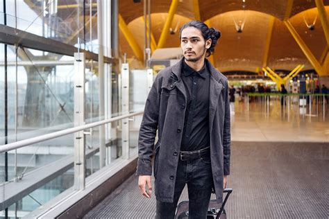 "Young Businessman With Suitcase Walking In The Airport Terminal." by Stocksy Contributor "Luis ...