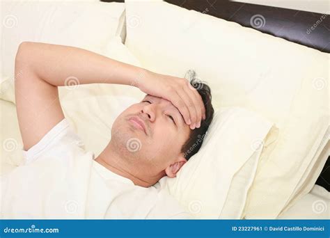 Young Man Lying Down In Bed Stock Image - Image of medical, hand: 23227961