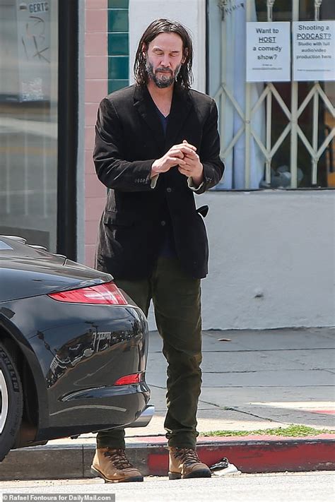 Keanu Reeves focuses on his side career as a bassist as he drops by a guitar shop in Hollywood ...