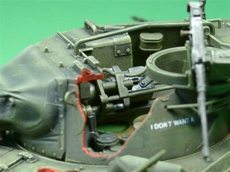 a close up of a toy tank on a green background