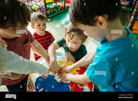 Children learning about countries with an inflatable globe ball Stock ...