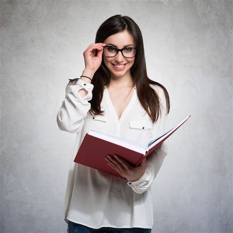 Premium Photo | Portrait of a young woman holding a book