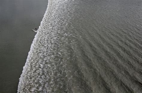 Feature - Bore Tide Surfing In Alaska Photograph by Streeter Lecka - Fine Art America