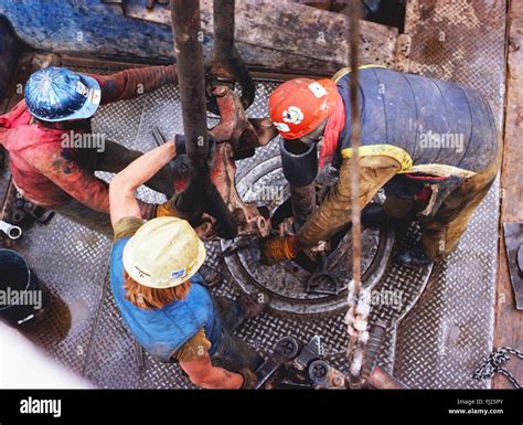 High view looking down on roughneck workers on oil rig, New Mexico, USA ...