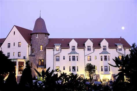 a large white building with a clock tower at the end of it's story