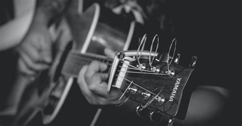 Grayscale Photography of Person Playing Yamaha Acoustic Guitar · Free Stock Photo