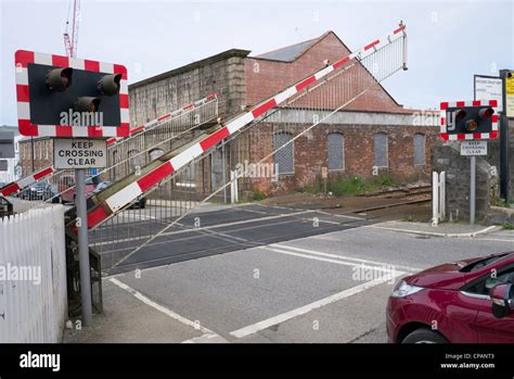 British railway level crossing barrier gate being raised after a Stock Photo, Royalty Free Image ...