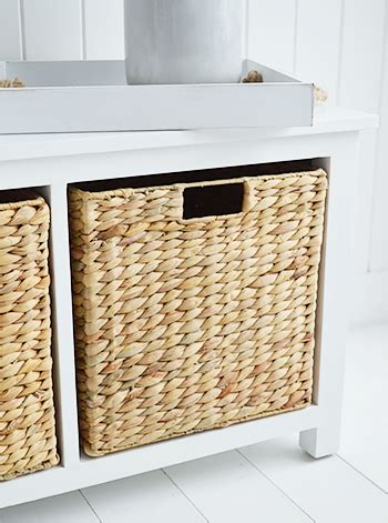 A white storage seat with baskets. Hall Furniture