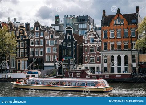 Cruise Tourist Boat in Damrak Canal in Amsterdam at Sunset. Editorial ...