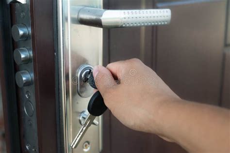 Locking Up or Unlocking Door with Key in Hand Stock Photo - Image of residence, protection: 99094024