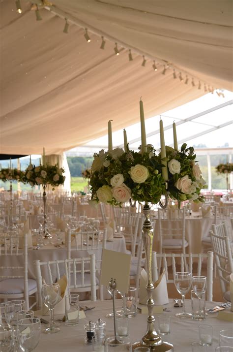 silver candelabras decorated with summer flowers | Wedding table decorations, Wedding table ...